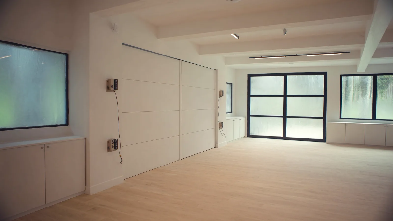 The same detached garage after ADU conversion — kitchenette, full bath, LVP flooring, separate entrance